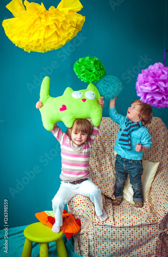 cute little brother and sister playing together in the room