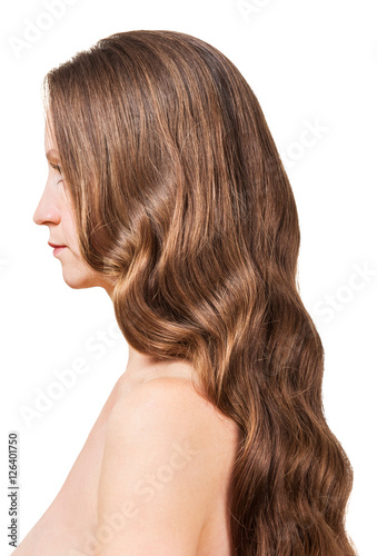 Woman with wavy brown hair isolated on white background.