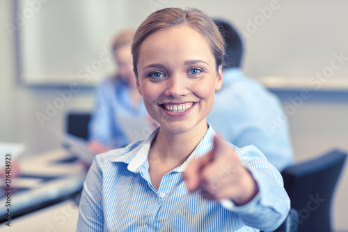 smiling businesswoman pointing finger on you Free Download smiling businesswoman pointing finger on you - GFXLoad