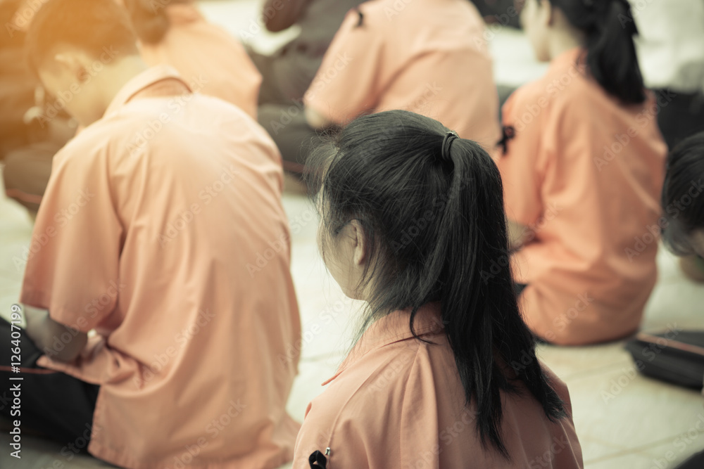 behind of female college student at campus, sitting in group behind of female college student at campus, sitting in group