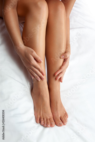 Fototapeta Naklejka Na Ścianę i Meble -  touching woman legs