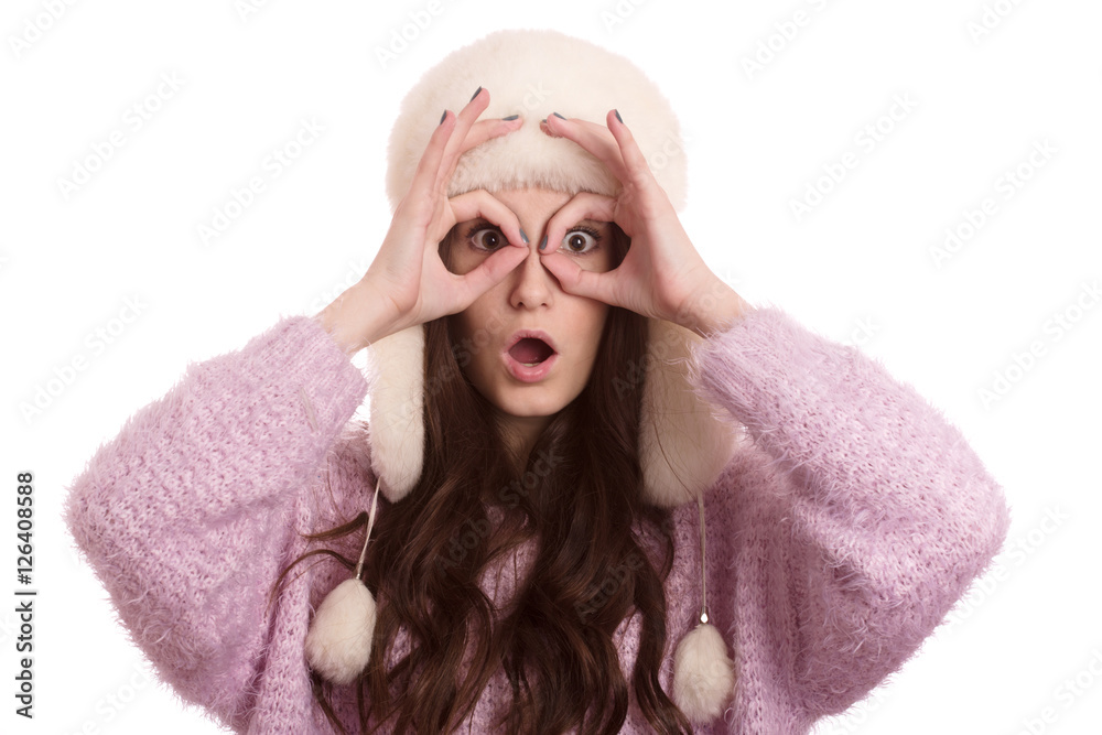 fun girl in winter hat making eyes isolated on white background