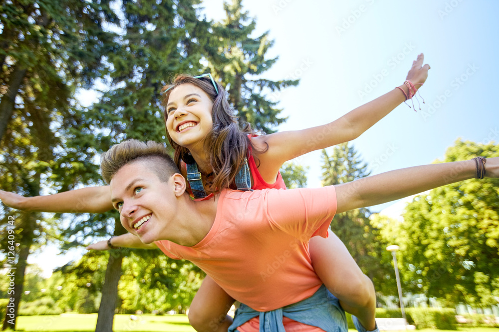 Fototapeta premium happy teenage couple having fun at summer park