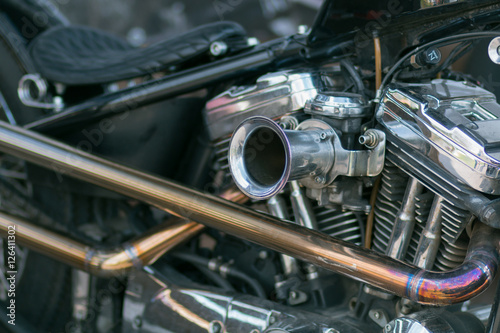 Motorcycle engine close-up. Chrome, shiny parts, wheels, exhaust. © zhdanovdi