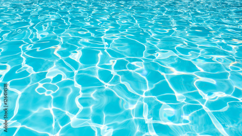 Water Surface in swimming pool with sun reflection