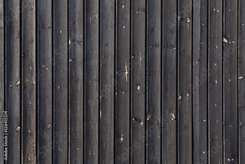 Black outdoor wooden wall, background texture