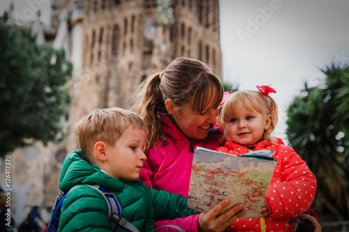 Family tourism - mother with kids travel in Barcelona