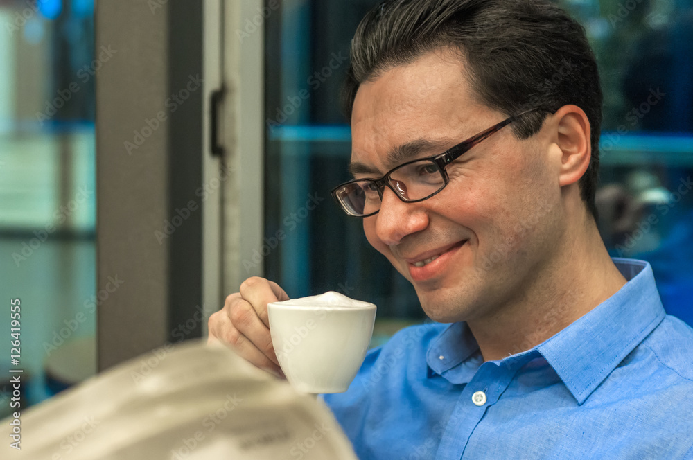 Portrait of young brunette hair businessman sitting in a coffee Portrait of young brunette hair businessman sitting in a coffee