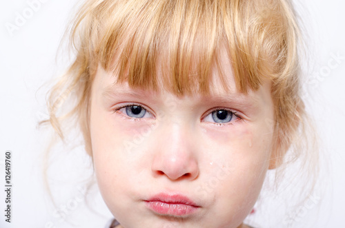little girl crying on a light background