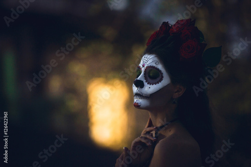 Fototapeta Naklejka Na Ścianę i Meble -  Portrait of a girl with scary artistic Halloween make-up outside