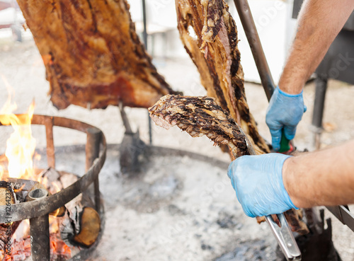 Traditional Argentinian asado roasted lamb grilled meat.