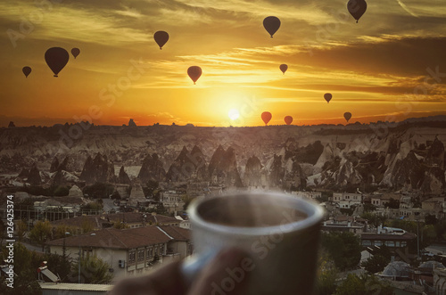 Morning coffe , Hot air balloons and amazing beautiful sunrise over Goreme in Cappadocia, Anatolia, Turkey