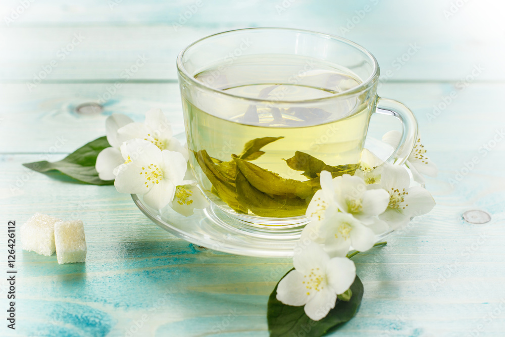 Green herbal tea with jasmine flowers, closeup Green herbal tea with jasmine flowers, closeup