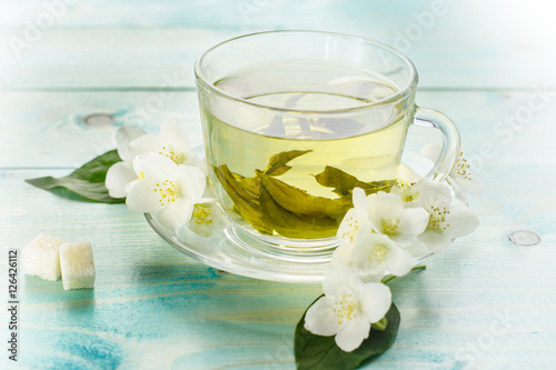 Green herbal tea with jasmine flowers, closeup