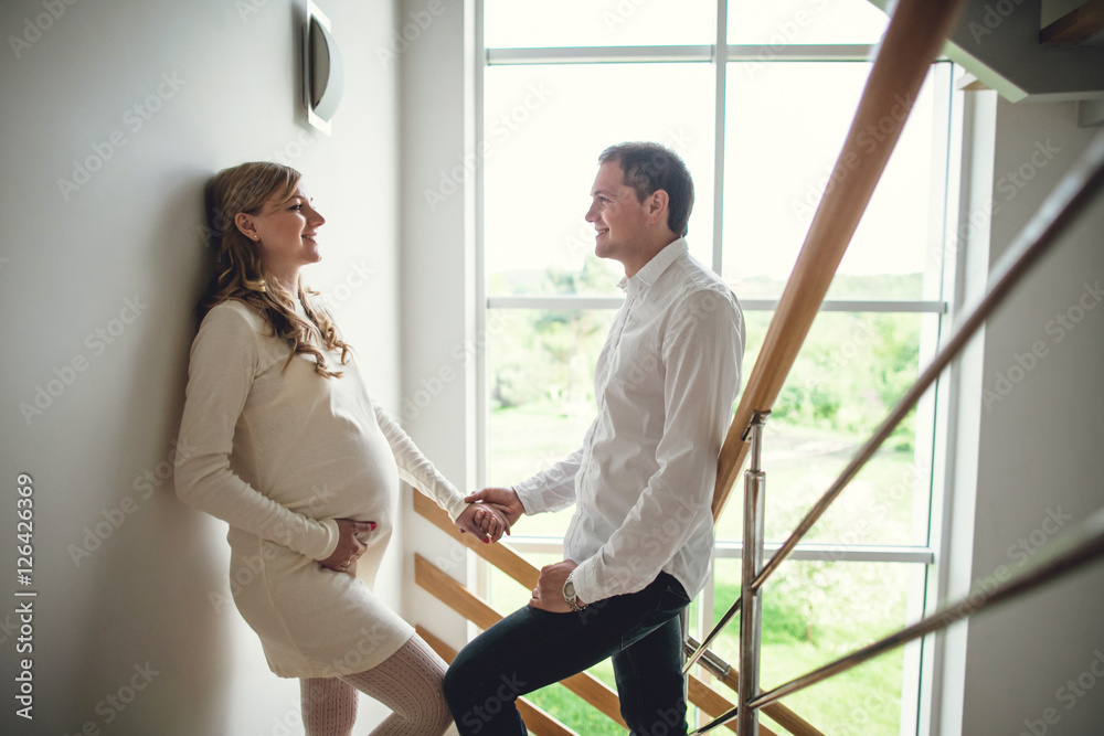 Fototapeta premium Happy pregnant and her husband at home