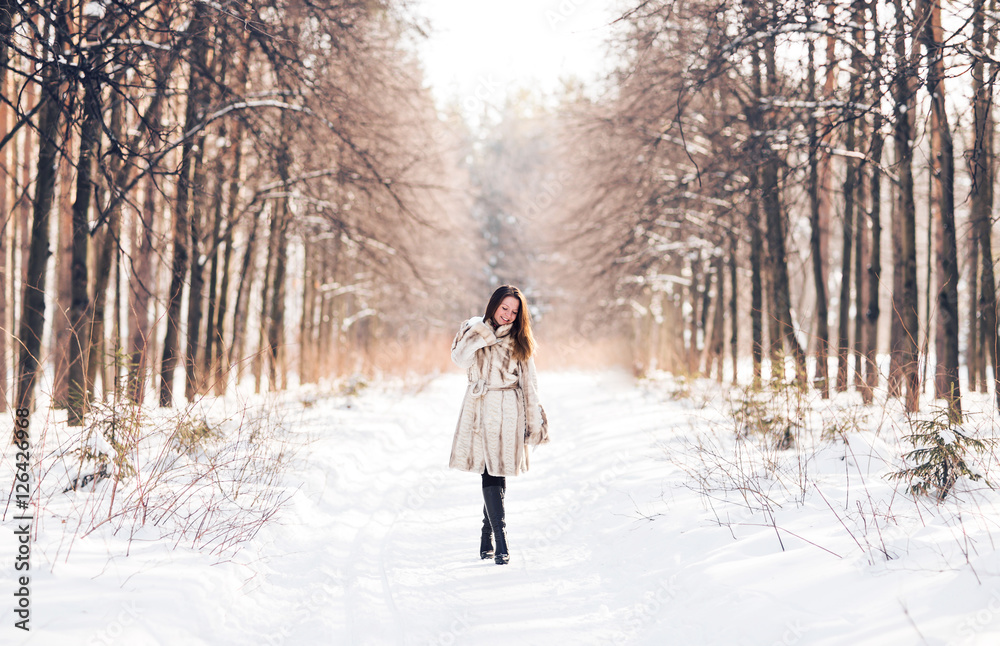 Girl walking in snow. Winter, cold and people concept