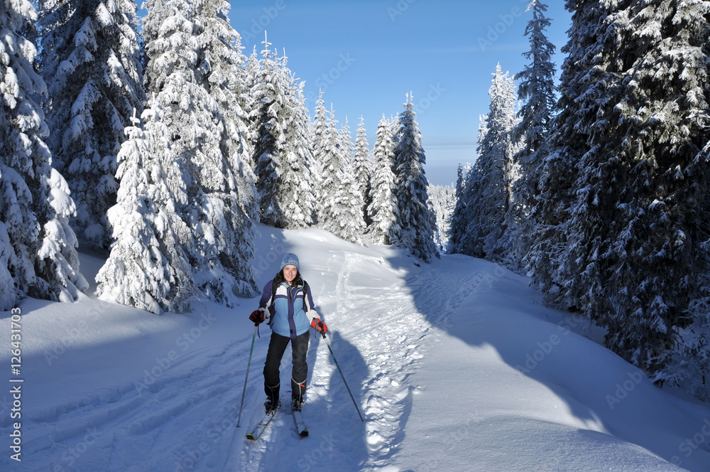 Backcountry skier touring in beautiful winter mountains