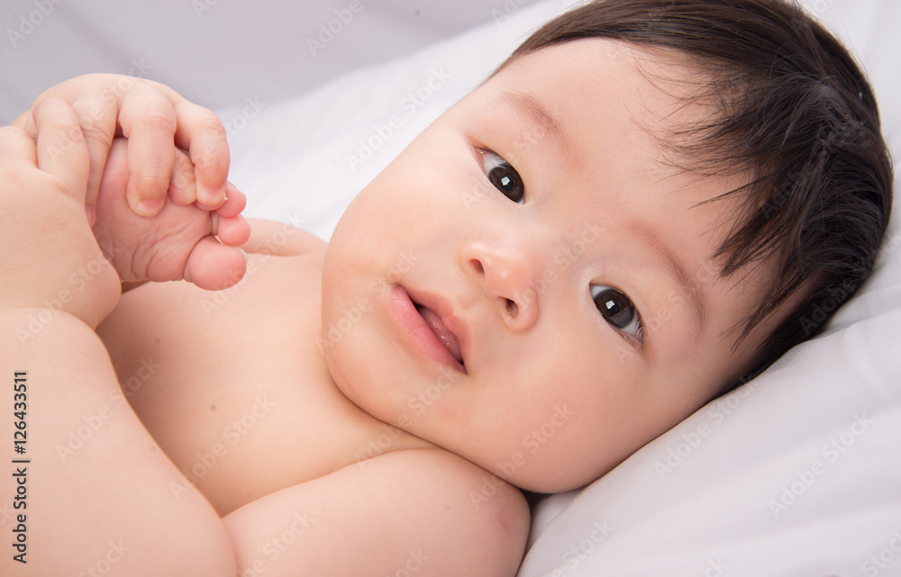 Portrait of cute Little asian boy 6 months old on the white bed Portrait of cute Little asian boy 6 months old on the white bed