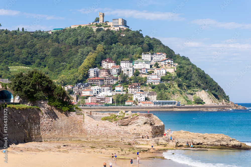 Fototapeta premium View to Igeldo, a quarter of San Sebastian. It is a small town located at the hillside of the same name towering over the west side of the Bay of La Concha one of the famous urban beaches in Europe