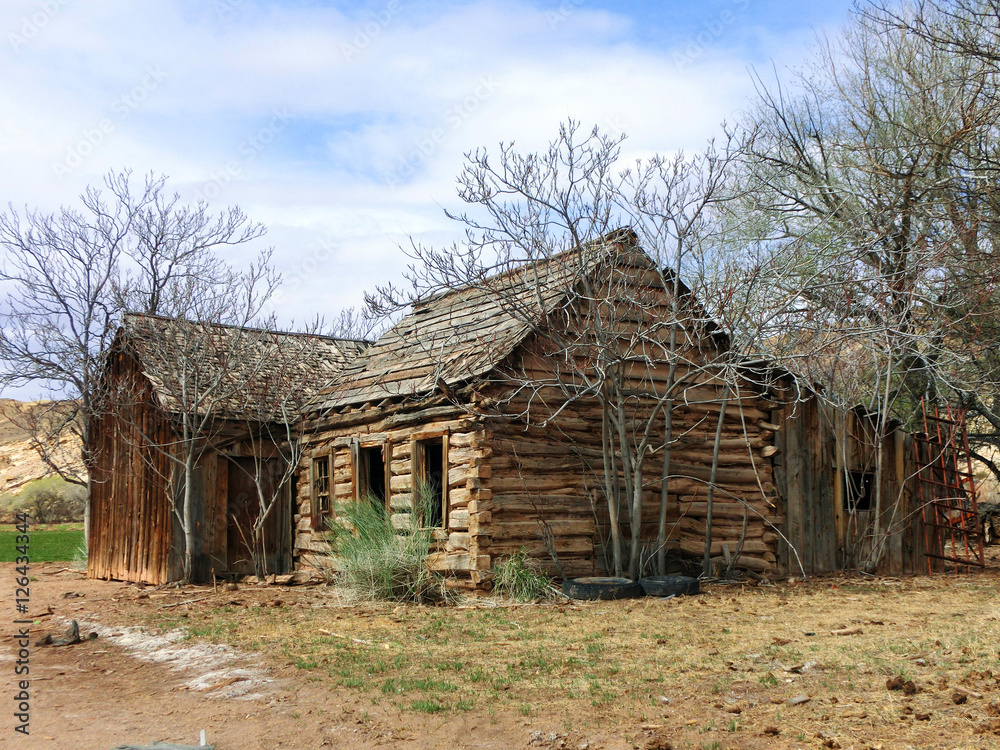 Abandoned old weathered log cabin in American desert Abandoned old weathered log cabin in American desert