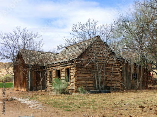 Abandoned old weathered log cabin in American desert