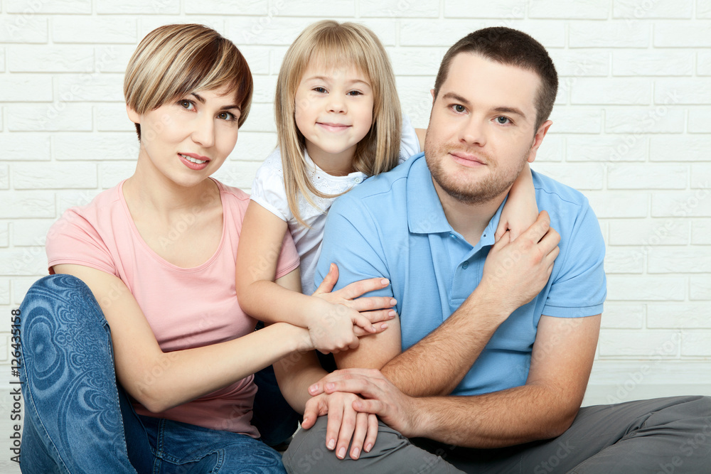 happy family mother, father and two children playing and cuddling at home on floor happy family mother, father and two children playing and cuddling at home on floor