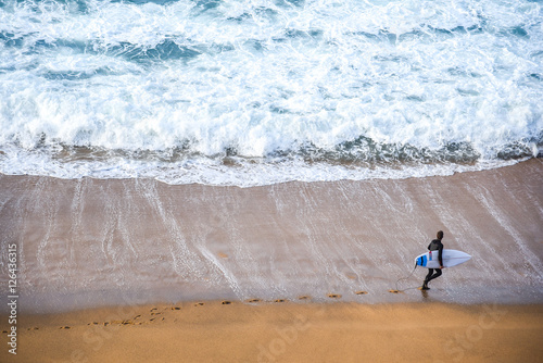 surfer man on the beach photo