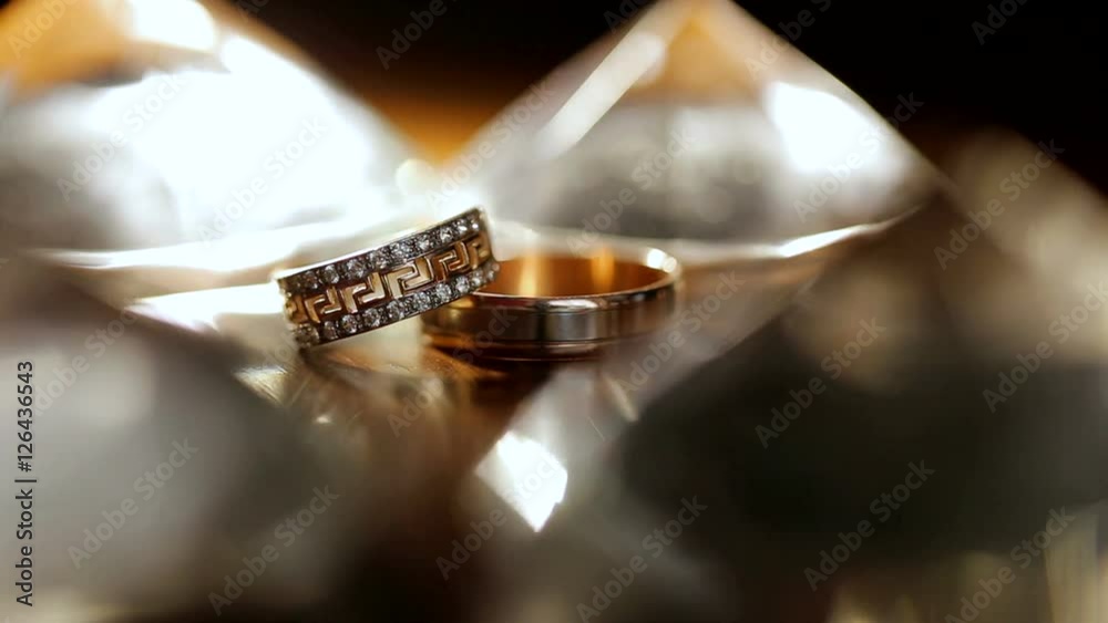 The two rings lie on the table. Wedding rings. Sparkling background. Jewelry.
