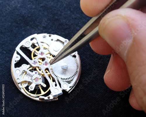 close up of watchmaker working on vintage watch