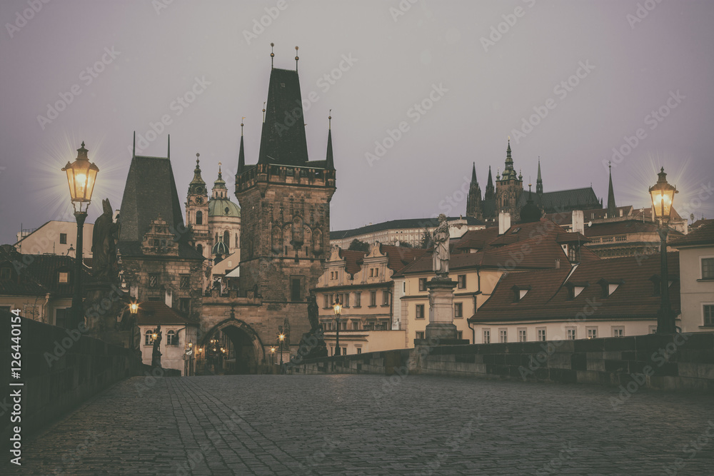 View from Charles bridge in Prague with red roofs, Czech Republic. Toned photo, vintage effect.