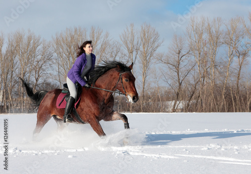 Equestrian model ride horseback through the snow fields