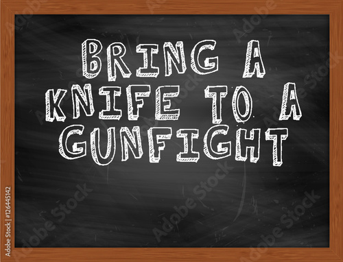 BRING A KNIFE TO A GUNFIGHT handwritten text on black chalkboard