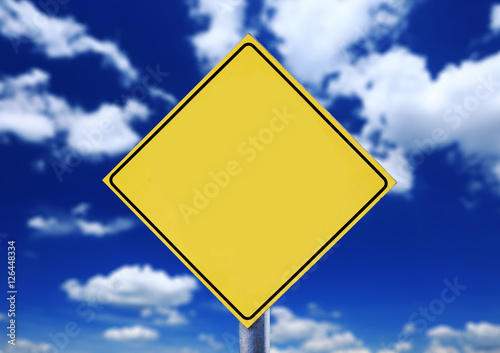 Blank yellow road sign with cloudscape
