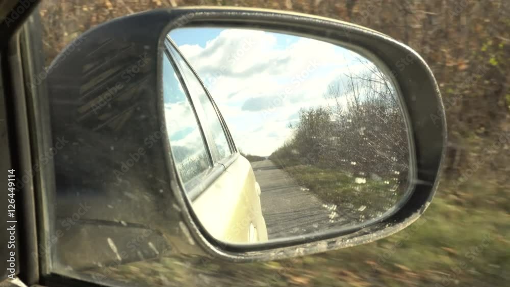 reflection in the mirror of a moving car. reflection in the mirror of a moving car.