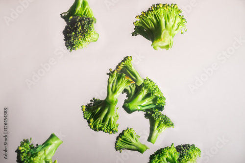 Freeze Dropping Green Brocolli on White Background