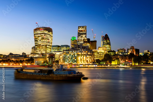 The bank district of central London with famous skyscrapers at sunset with amazing blue sky and reflection, London, United Kingdom © marekkijevsky