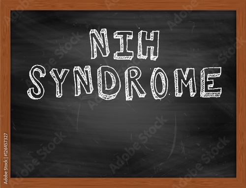 NIH SYNDROME handwritten text on black chalkboard photo