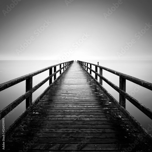 The Baltic Sea coast with pier in Sassnitz on the island Ruegen during rainy day, Northern Germany.