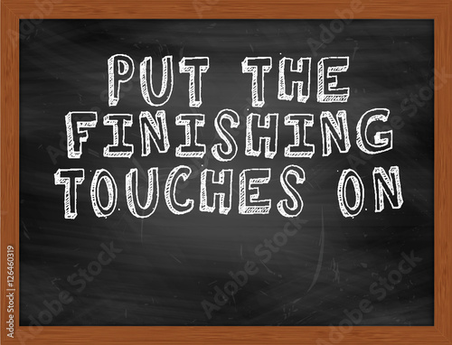 PUT THE FINISHING TOUCHES ON handwritten text on black chalkboar photo