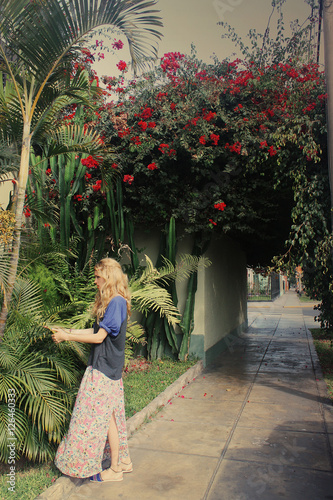 pretty blond caucasian girl standing on summer street, Lima, Per photo