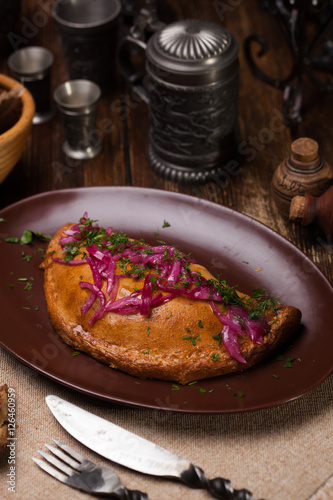 Meat pies  on top of a red onion and sauce