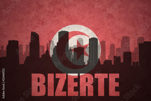 abstract silhouette of the city with text Bizerte at the vintage tunisian flag photo