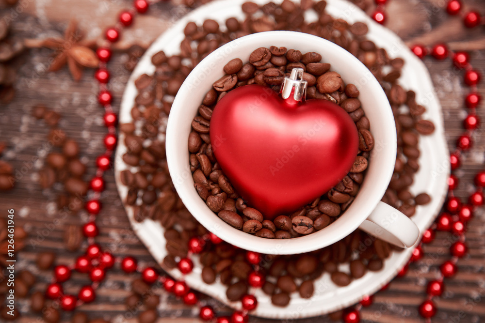 Heart shape toy and cup on Christmas wooden background. Heart shape toy and cup on Christmas wooden background.