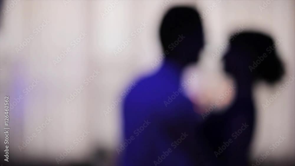 Dancing at night blurred silhouetted couple motion background close up. Man and woman happily fast perform moving together. Two anonymous persons on dance-floor unfocused in neon light Dancing at night blurred silhouetted couple motion background close up. Man and woman happily fast perform moving together. Two anonymous persons on dance-floor unfocused in neon light