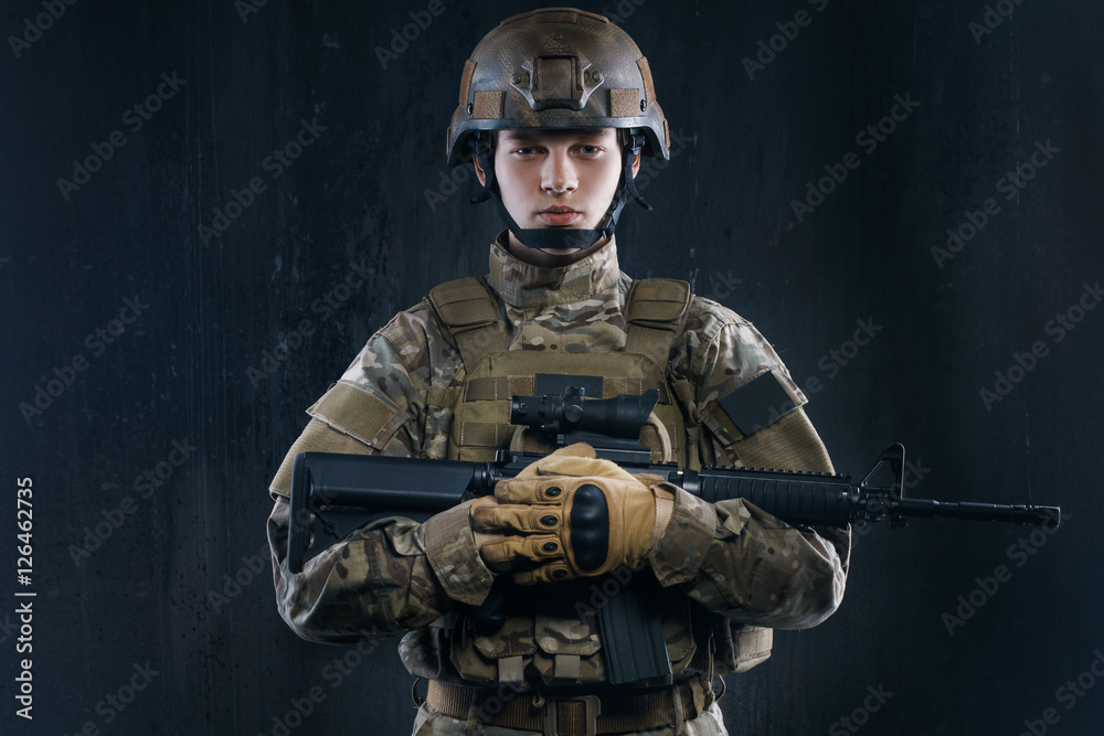Airsoft - a game for real men. Special forces soldier with rifle on dark background. Airsoft - a game for real men. Special forces soldier with rifle on dark background.