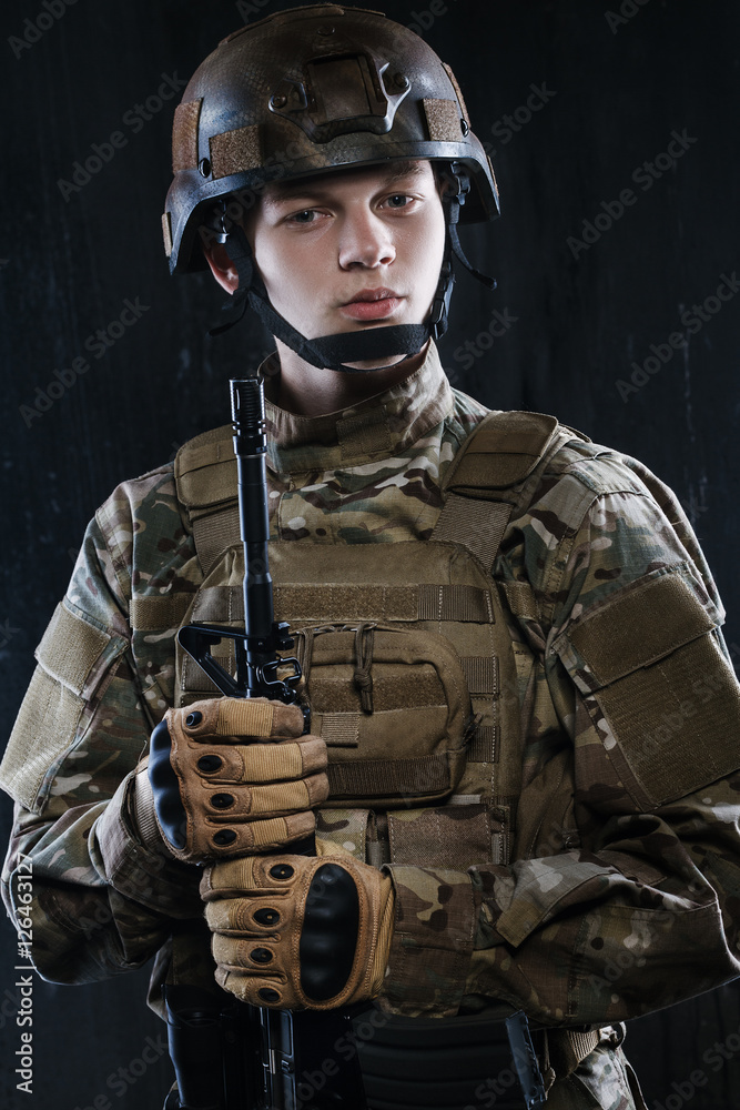 Portrait of a young soldier. The hands holding the rifle. Proud and confident quite complete. Portrait of a young soldier. The hands holding the rifle. Proud and confident quite complete.