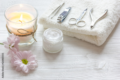 spa nail care with aroma candle on wooden background