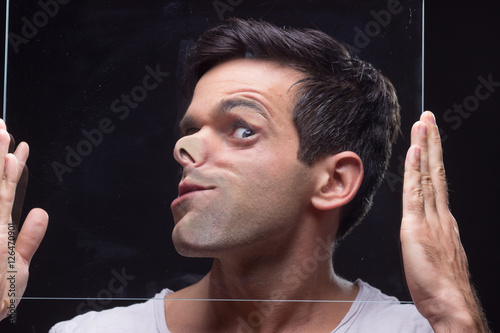 young man head face pressed against glass