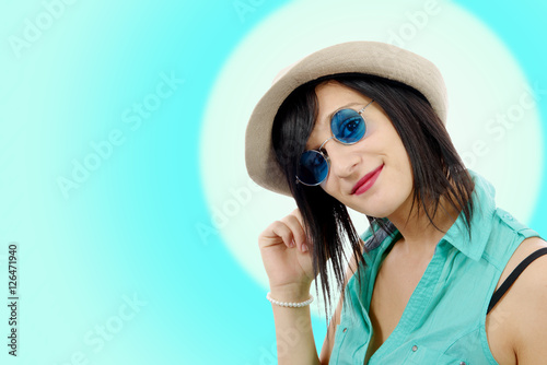 pretty brunette girl with a summer hat and blue sunglasses
