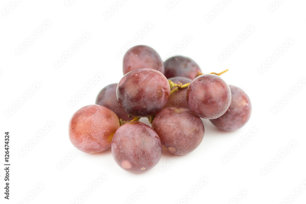 Fototapeta premium Ripe red grape with leaves isolated on white